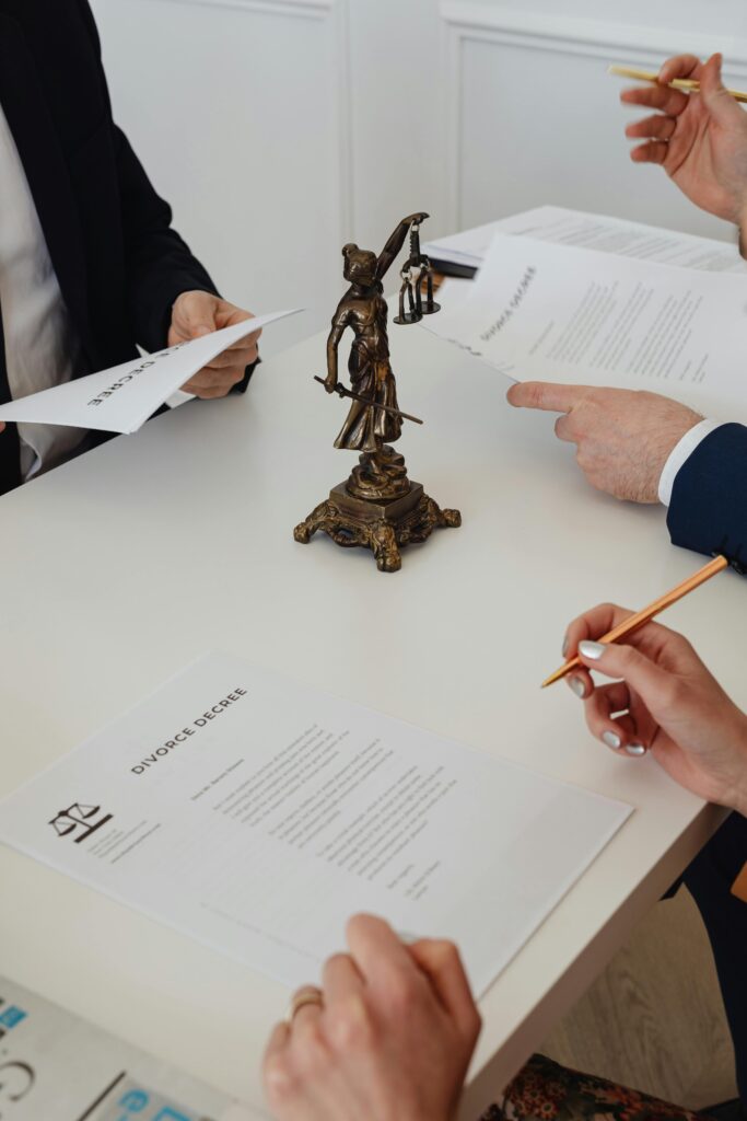 pexels-photo-7876042-7876042 Three professionals reviewing divorce papers in a law office setting.